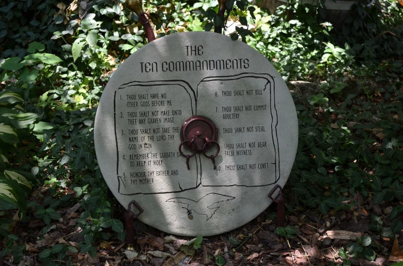 a sign that reads the ten command commandments, by Loren Munk, flickr, concrete art, in the garden, circular, in savannah, an epic fantasy