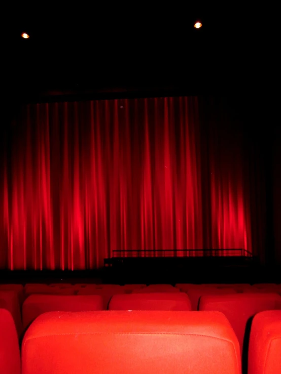 a row of red seats in front of a red curtain, a picture, hd movie photo, blog-photo, wide shot photo, amazing photo