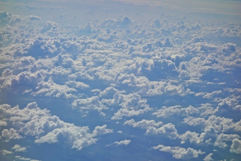 a blue sky filled with lots of white clouds, by Daniel Taylor, precisionism, bird\'s eye view, photo ( far _ shot ), heaven on earth, “puffy cloudscape