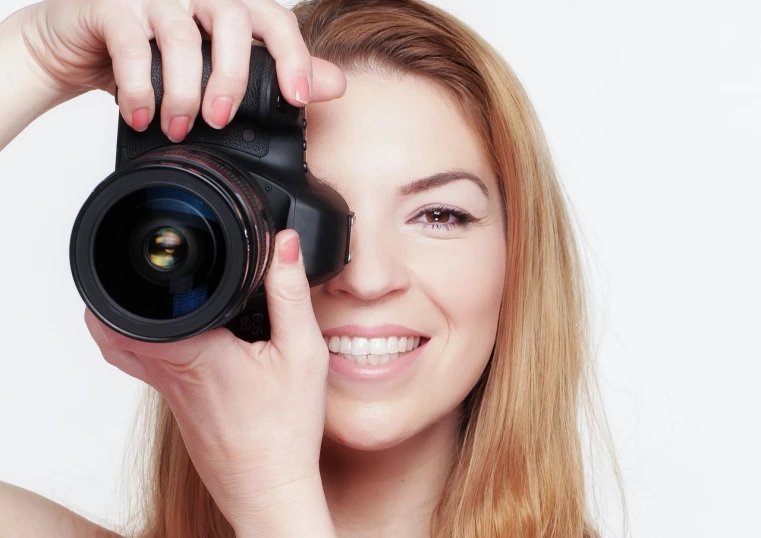 a woman taking a picture with a camera, by Juan O'Gorman, shutterstock, art photography, close - up studio photo, smiling for the camera, photo of the girl, professional headshot