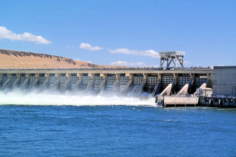 a large body of water with a dam in the background, by Scott M. Fischer, shutterstock, hurufiyya, overflowing energy, circuit, water-cooled, usa-sep 20