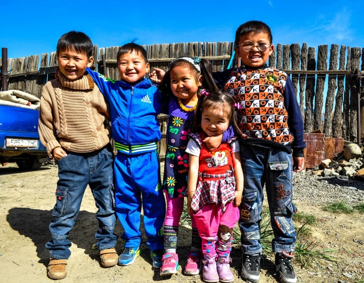 a group of children standing next to each other, flickr, toyism, sci - fi mongolian village, denim, photo taken in 2 0 2 0, bright smiles