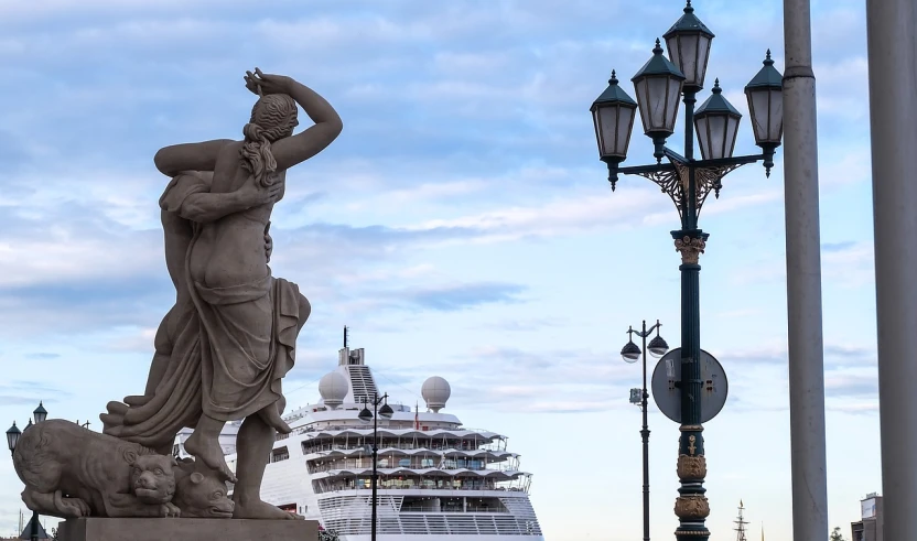 a statue of a man and a dog in front of a cruise ship, a statue, by Raymond Normand, renaissance, the god athena, lamp posts, high resolution photo, princess in foreground