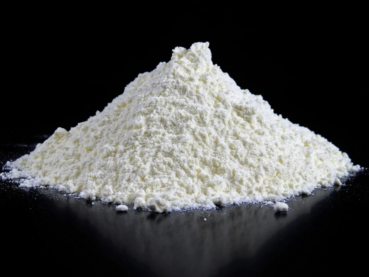 a pile of flour sitting on top of a table, by Jeffrey Smith, plasticien, on a black background, textured base ; product photos, steroid use, cheese