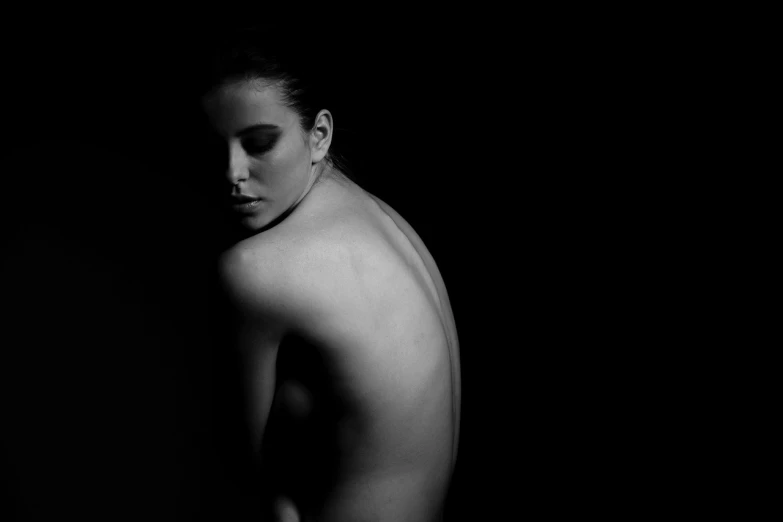 a black and white photo of a naked woman, a black and white photo, inspired by Peter Basch, minimalism, low key lights, exposed back, portrait of penelope cruz, nicolas delort