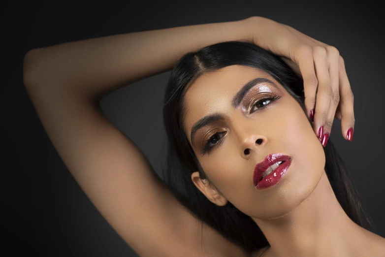 a woman is posing with her hands on her head, a portrait, by Ric Estrada, trending on cg society, indian super model, glossy lips, close - up studio photo, angled shot