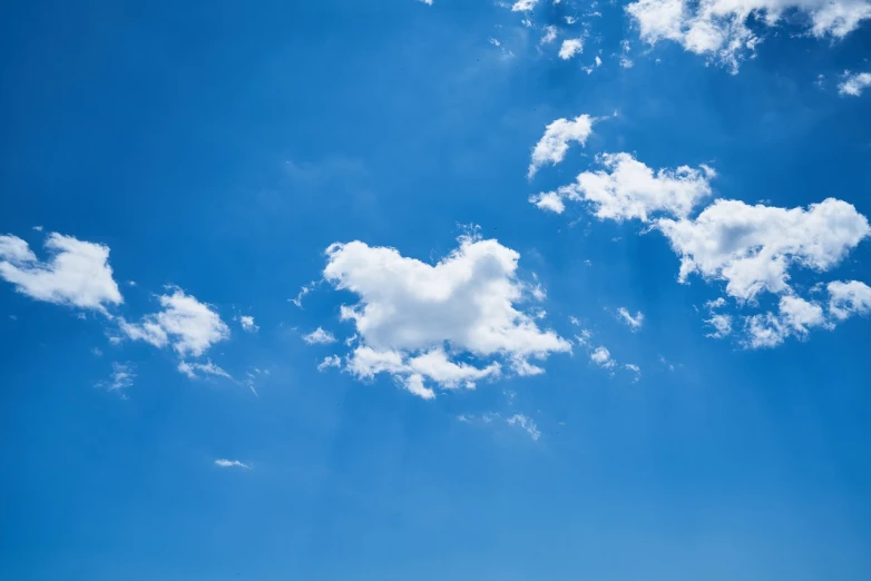 a large jetliner flying through a blue sky, a stock photo, minimalism, cloud in the shape of a dragon, instense god rays in the sky, summer clear blue sky, sunny day background