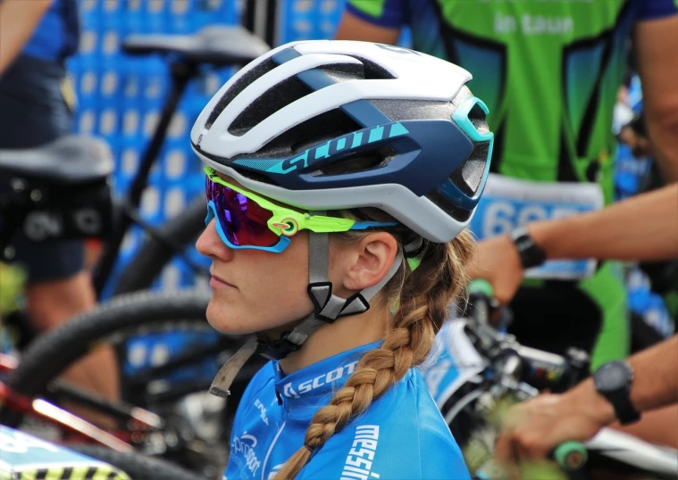 a close up of a person wearing a bike helmet, inspired by Louisa Matthíasdóttir, sport glasses, photo taken in 2 0 2 0, tight bun, beautiful blue armet helmet