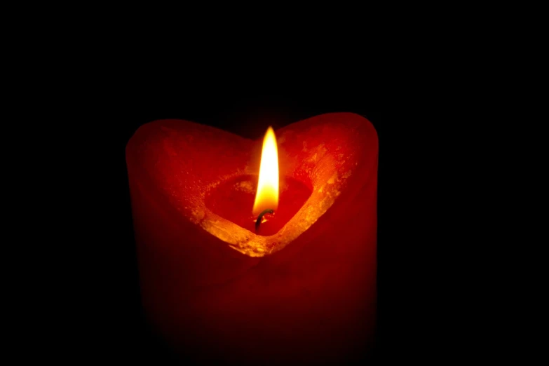 a lit candle in the shape of a heart, a picture, hurufiyya, mid shot photo