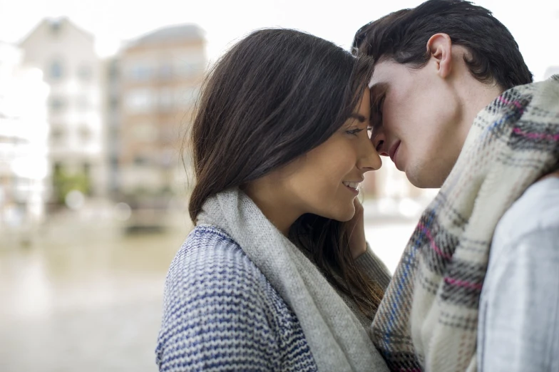 a man and a woman standing next to each other, shutterstock, romanticism, smelling good, london, at the waterside, close up angle