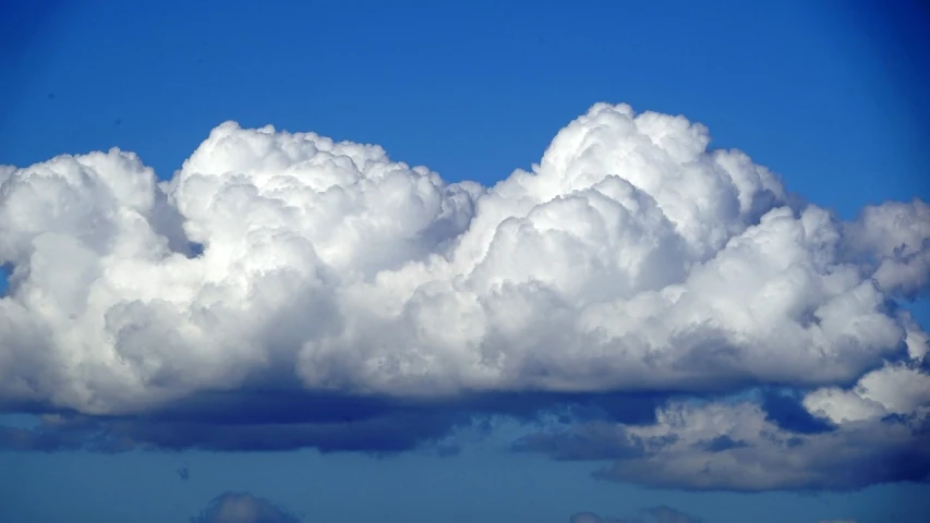 a large cloud in the middle of a blue sky, precisionism, cumulus tattoos, fluffy, wikimedia, stormy wheater