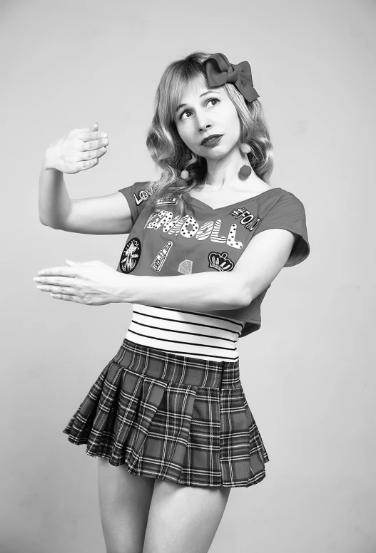 a black and white photo of a woman in a skirt, a black and white photo, pixabay, kitsch movement, shrugging arms, cosplay photo, professional studio photograph, soda themed girl