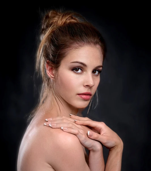 a beautiful young woman posing for a picture, a portrait, by Dimitre Manassiev Mehandjiysky, shutterstock, art photography, hair styled in a bun, bare shoulders, jewelry photography, hands behind her pose!