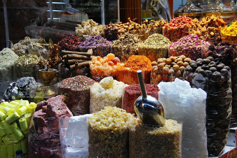 a display case filled with lots of different types of food, by Edward Ben Avram, pexels, renaissance, inside an arabian market bazaar, mortar and pestle, shiny skin”, petals