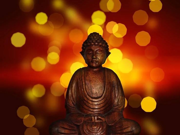 a buddha statue sitting on top of a wooden table, pexels, bokeh color background, brown red and gold ”, bokeh photo