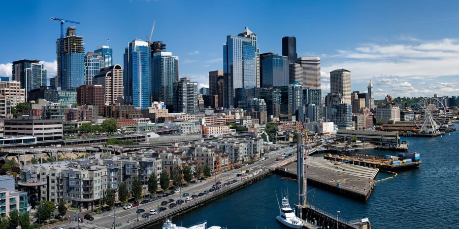 a large body of water with a city in the background, by Jason Felix, shutterstock, seattle, city docks, hd aerial photography, ultrawide establishing shot