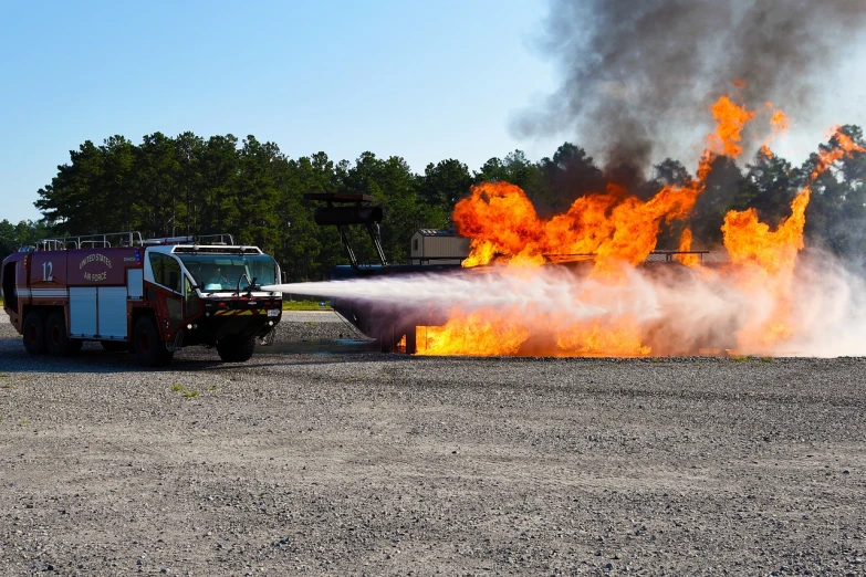 a fire truck spraying water on a fire, auto-destructive art, launch test, trex, starting engines nitro jet drive, training