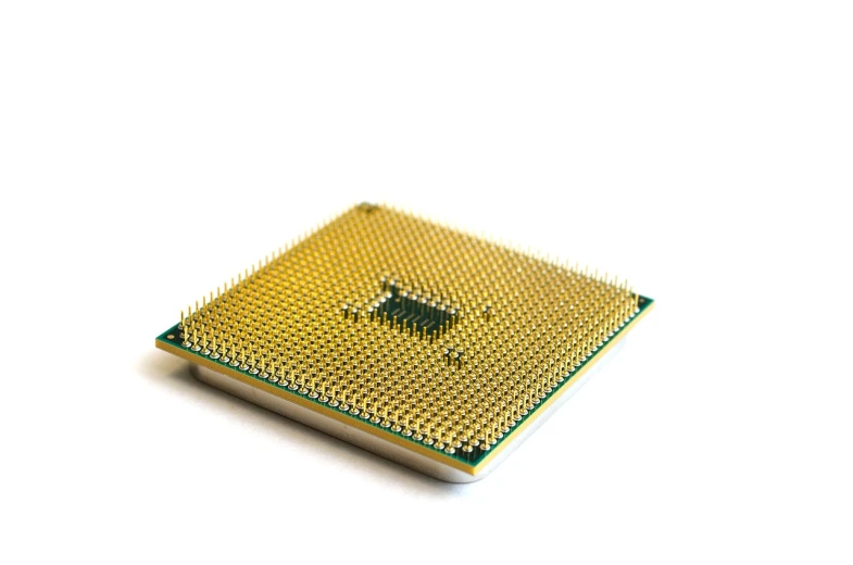 a close up of a computer chip on a white surface, shutterstock, golden computers, modern very sharp photo, high detail product photo, cpu