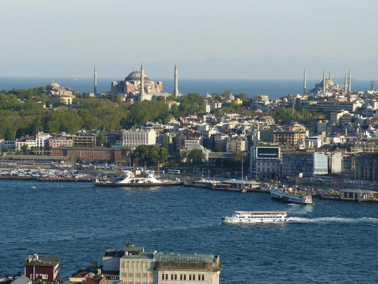 a large body of water with a city in the background, a picture, hurufiyya, turkish and russian, bustling, grayish, southern european scenery