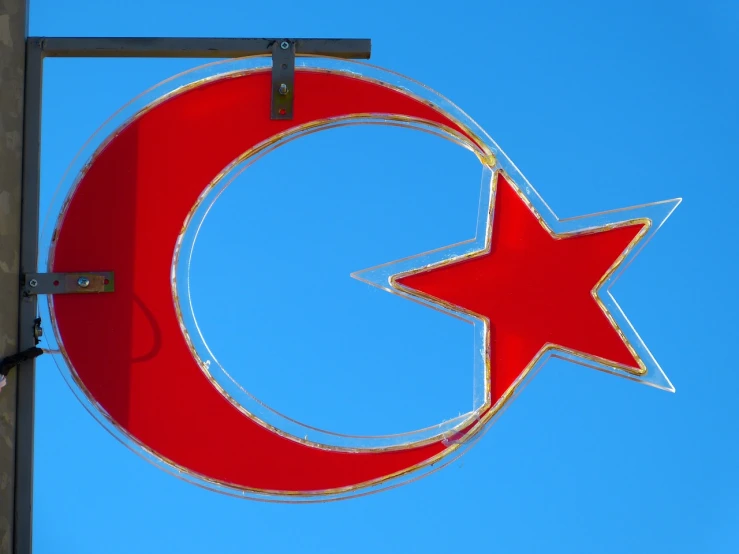 a red star and crescent sign against a blue sky, by Leon Polk Smith, flickr, hurufiyya, turkey, ultrafine detail ”, bar, pork