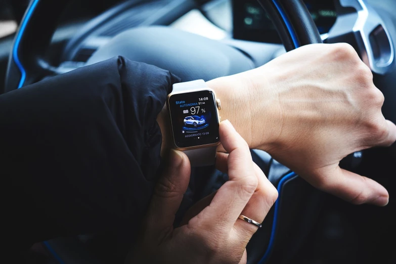 a close up of a person holding an apple watch, a picture, by Adam Marczyński, shutterstock, bmw i 8, freezing, stock photo