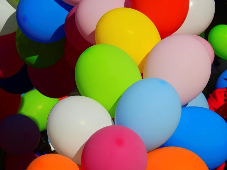 a bunch of colorful balloons floating in the air, a picture, by Doug Ohlson, color field, middle close up shot, noon, colored neons, hug