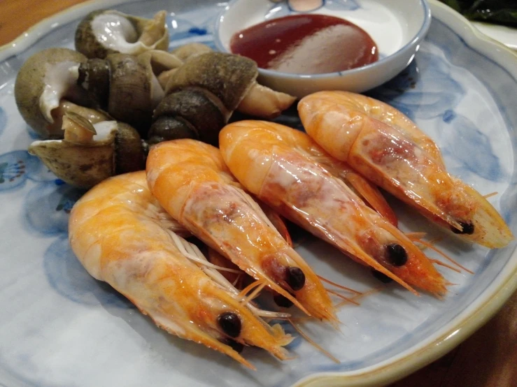 a close up of a plate of food with shrimp, a picture, flickr, shin hanga, snail, taiwan, ghost shrimp, ready to eat