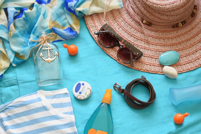 a hat, sunglasses and other items laid out on a table, shutterstock, plasticien, turquoise water, detail, feminine, bottle