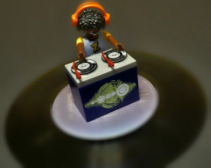 a close up of a figurine of a dj, cg society contest winner, funk art, minifigure, [ overhead view ]!!, spinning records, highly detailed product photo