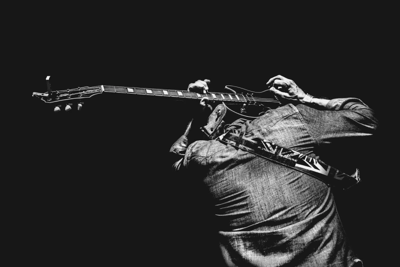 a black and white photo of a man playing a guitar, by Matija Jama, pexels, figuration libre, aaron horkey style, action bronson, playing a gibson les paul guitar, vertical wallpaper