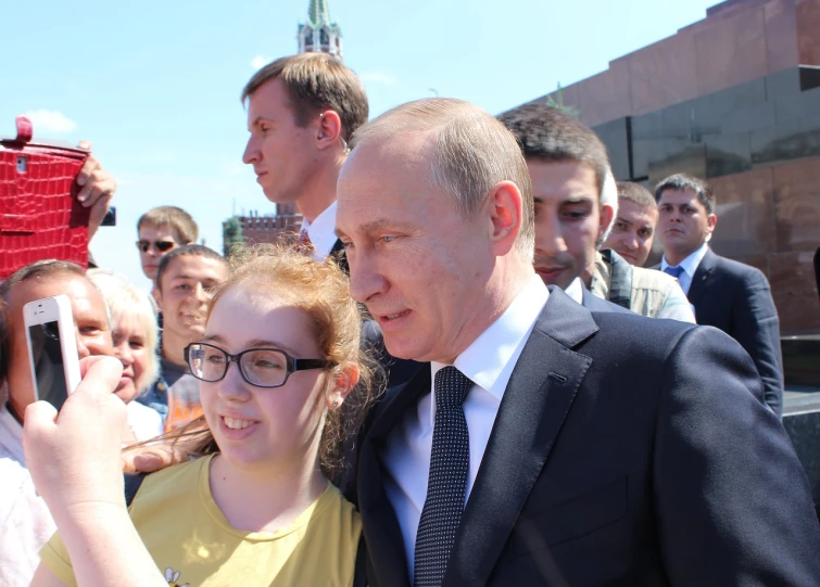 a woman taking a picture of a man in a suit and tie, by Nikita Veprikov, neoism, photo of putin, with a kid, summer day, square