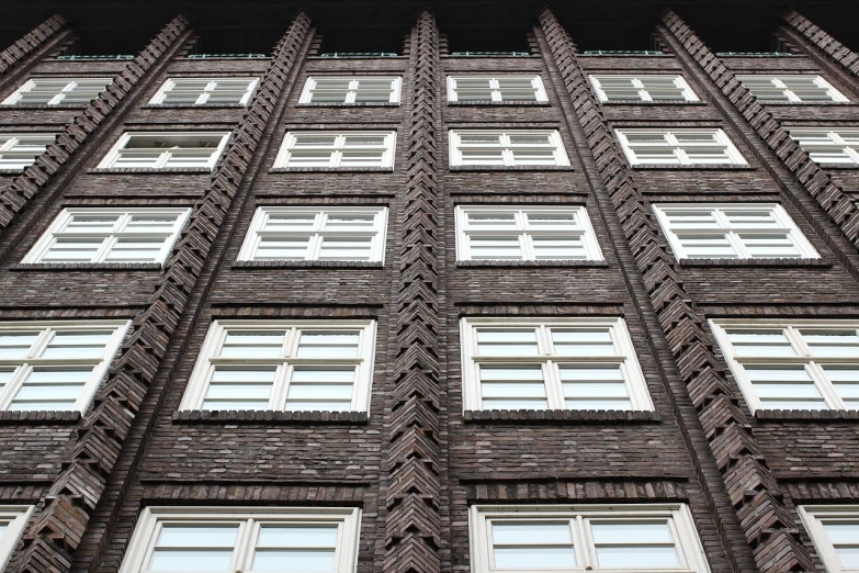 a tall brick building with lots of windows, inspired by Matthias Jung, flickr, zig zag, modern high sharpness photo, high details photo, photo of a beautiful window