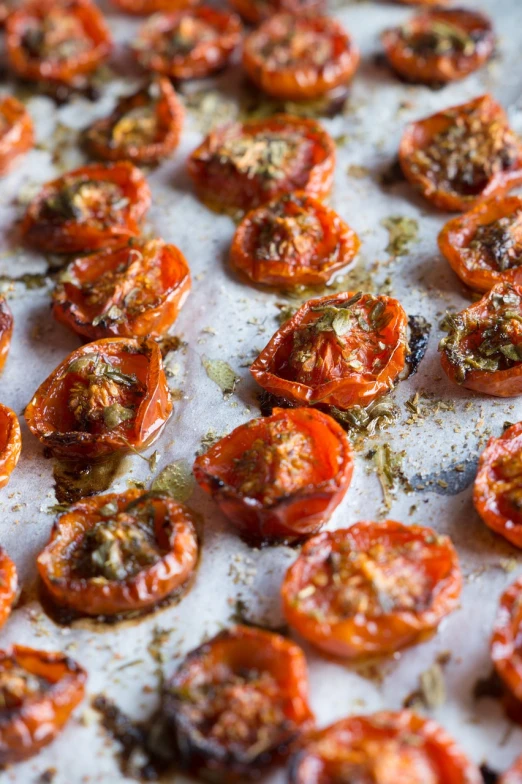 a close up of a tray of tomatoes, dried herbs, molten, scores, profile image