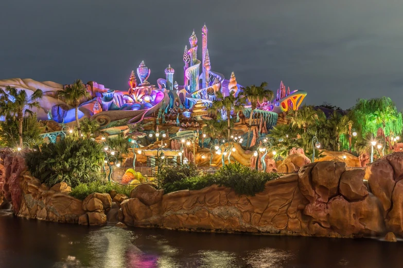 disneyland's fantasy land lit up at night, a picture, by Walt Disney, tumblr, maximalism, little mermaid, hdr colors, paradise in the background, sci-fiish landscape