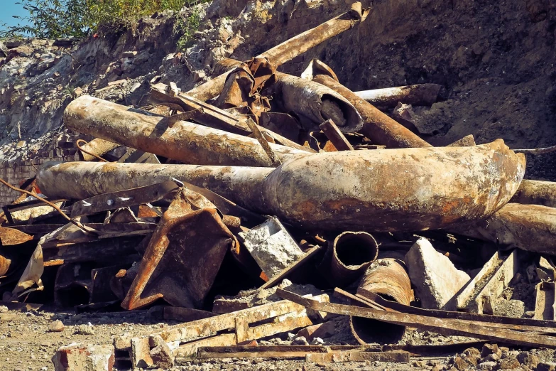 a pile of rusty pipes sitting on top of a pile of rubble, renaissance, abandoned railroads, biroremediation, full photo, vessels