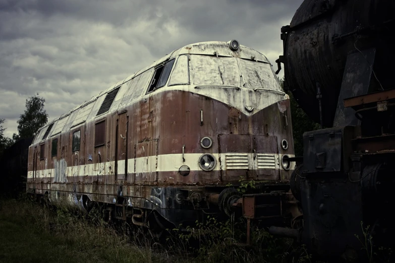 a train that is sitting in the grass, a portrait, unsplash, graffiti, bleak apocalyptic style, rusted junk, profile picture 1024px, overcast mood