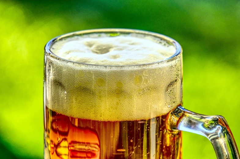 a glass of beer sitting on top of a table, shutterstock, photorealism, beautiful sunny day, macro photo, pc screen image, stock photo