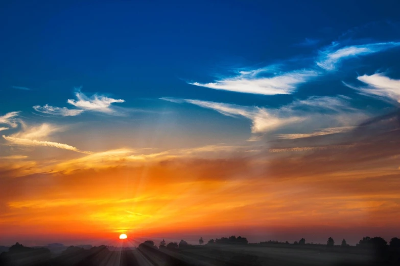 the sun is setting behind the clouds in the sky, a picture, by Hans Schwarz, beautiful wallpaper, orange and blue colors, blue - yellow sky, bright godrays