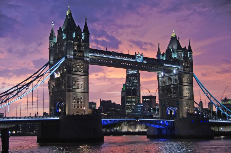 a very tall bridge over a body of water, a picture, by Joseph Henderson, pexels contest winner, art nouveau, tower bridge, purple glow, three towers, 6 4 0
