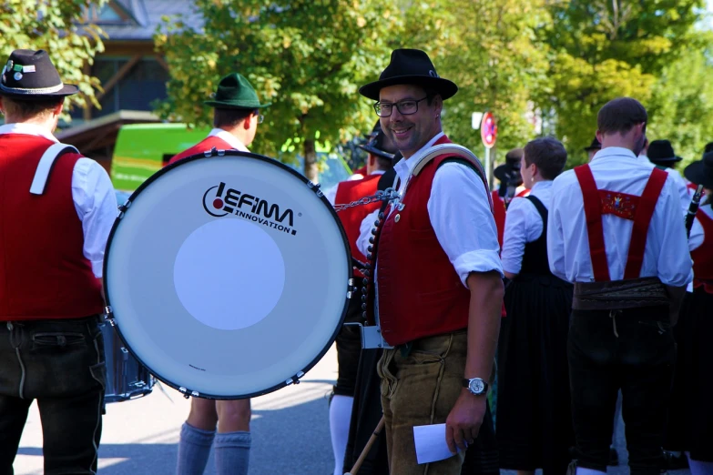 a group of men standing next to each other on a street, by Bernd Fasching, flickr, happening, mouse holding a drum, octoberfest, uniform, 15081959 21121991 01012000 4k