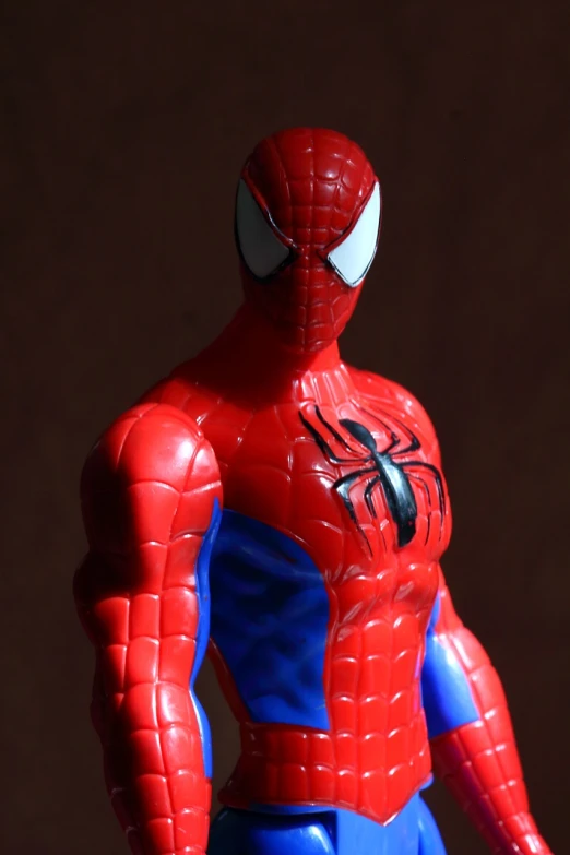 a close up of a figurine of a spider - man, inspired by Alton Tobey, pexels, slightly smiling, standing in a heroic figure, mary jane, slightly muscular