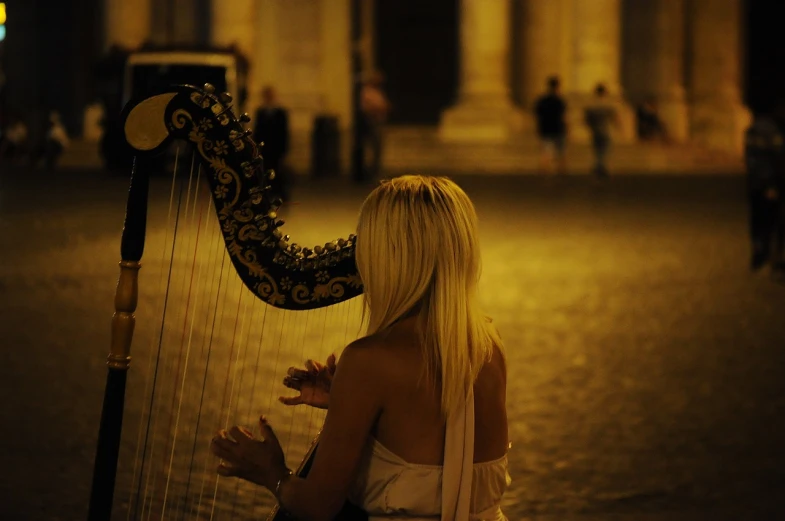 a woman in a white dress playing a harp, a picture, tumblr, watching night streets, roma, blond, jenny seville