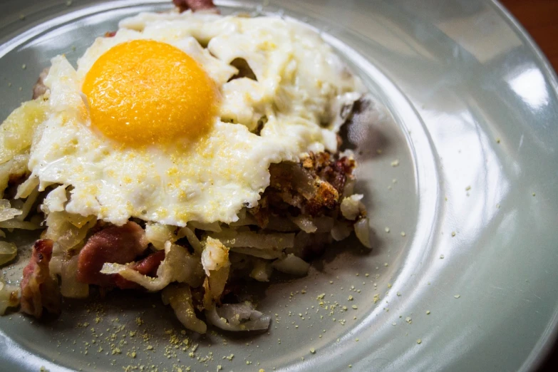 a close up of a plate of food with an egg on top, by Joe Bowler, red meat shreds, usa-sep 20, gluttony, fry