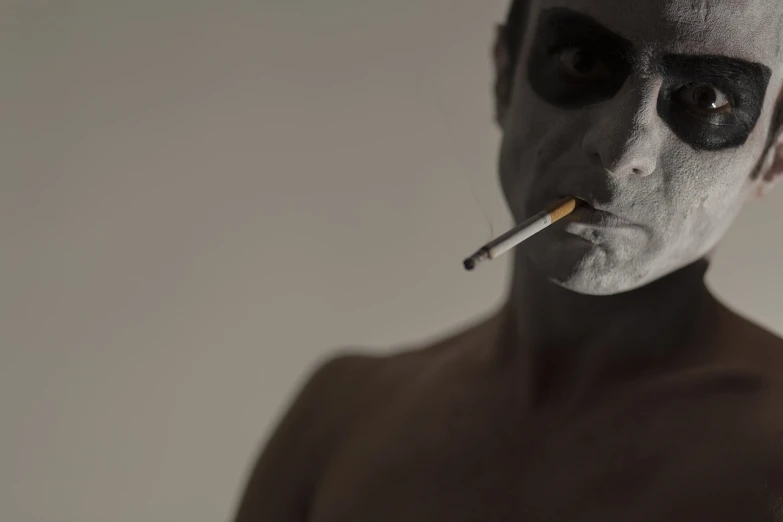 a man with a cigarette in his mouth, a portrait, inspired by Robert Mapplethorpe, bauhaus, portrait of a grey alien, cinematic body shot, wearing bandit mask, 33mm photo