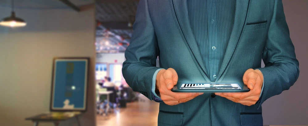 a man in a suit holding a laptop, a digital rendering, by Kurt Roesch, pixabay, took on ipad, indoor shot, vp of marketing, middle shot waist up