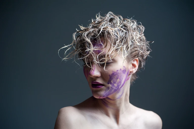a woman with purple paint on her face, a portrait, inspired by Bert Stern, flickr, action painting, short curly blonde haired girl, androgynous male, concept photoset, a messy
