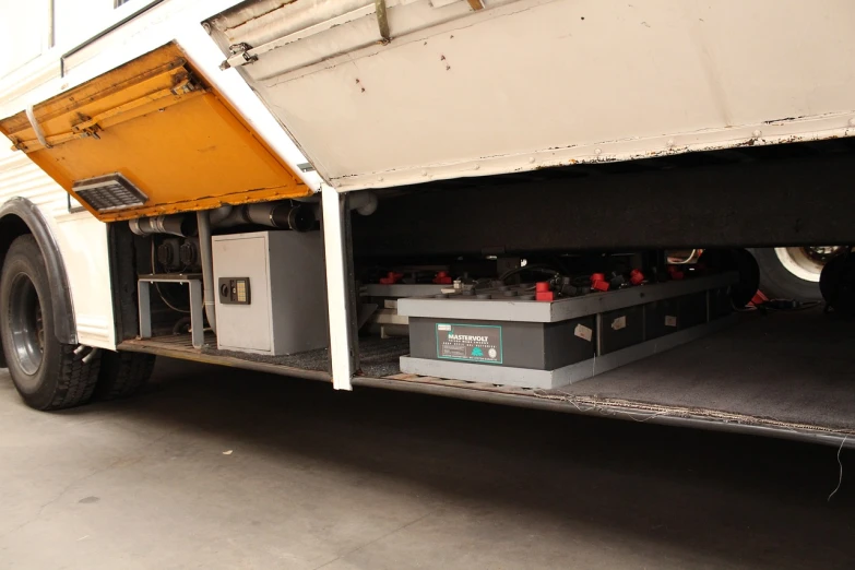 a truck with a bunch of batteries inside of it, by Hugo van der Goes, flickr, underside, underground facility, vehicle profile, bangalore