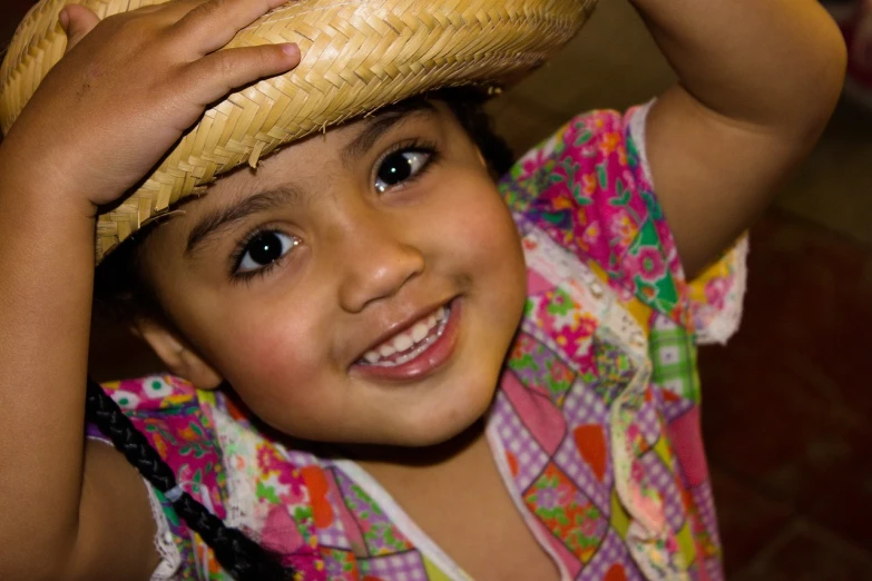 a little girl with a straw hat on her head, by Juan O'Gorman, flickr, gorgeous latina face, shy smile, slide show, smiling and dancing