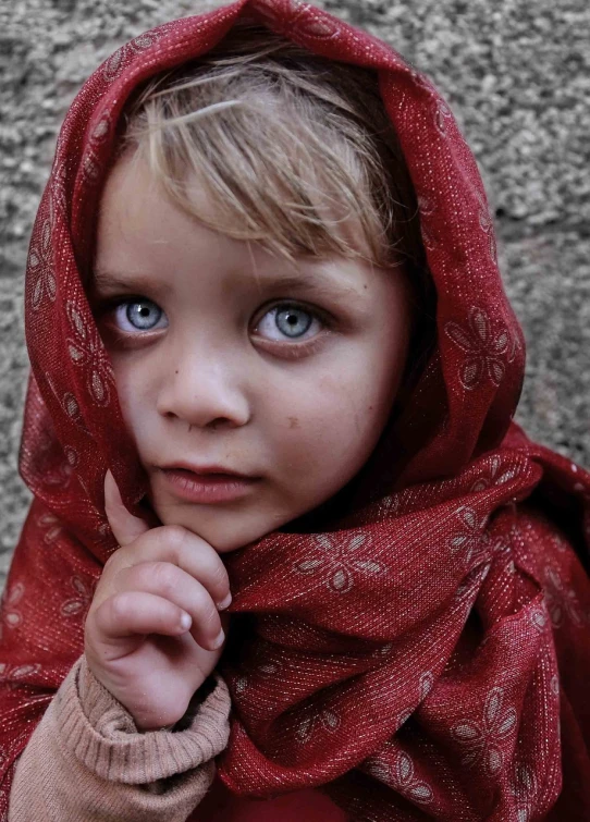 a little girl with blue eyes wearing a red scarf, a picture, inspired by Steve McCurry, sad cerulean eyes, beautiful picture of stray, tiny girl looking on, pointed face and grey eyes