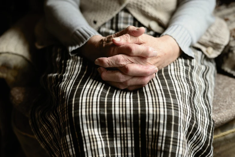 a close up of a person holding their hands, old fashion, seated, 7 0 years old, stunning lines